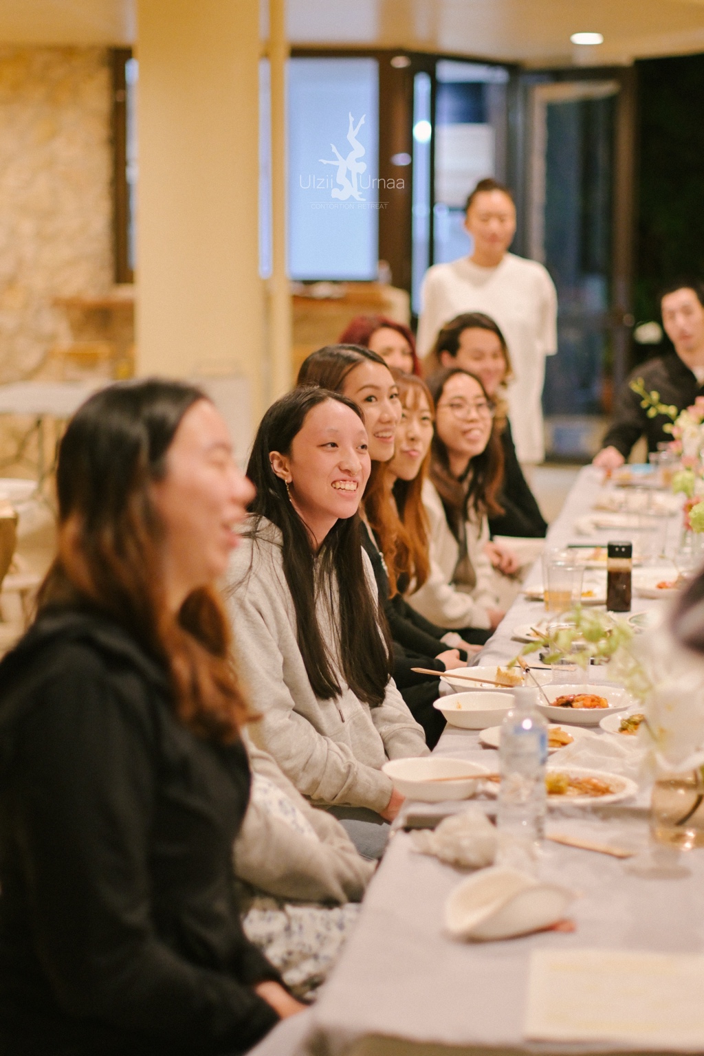 Retreat participants gathering around a shared dinner table